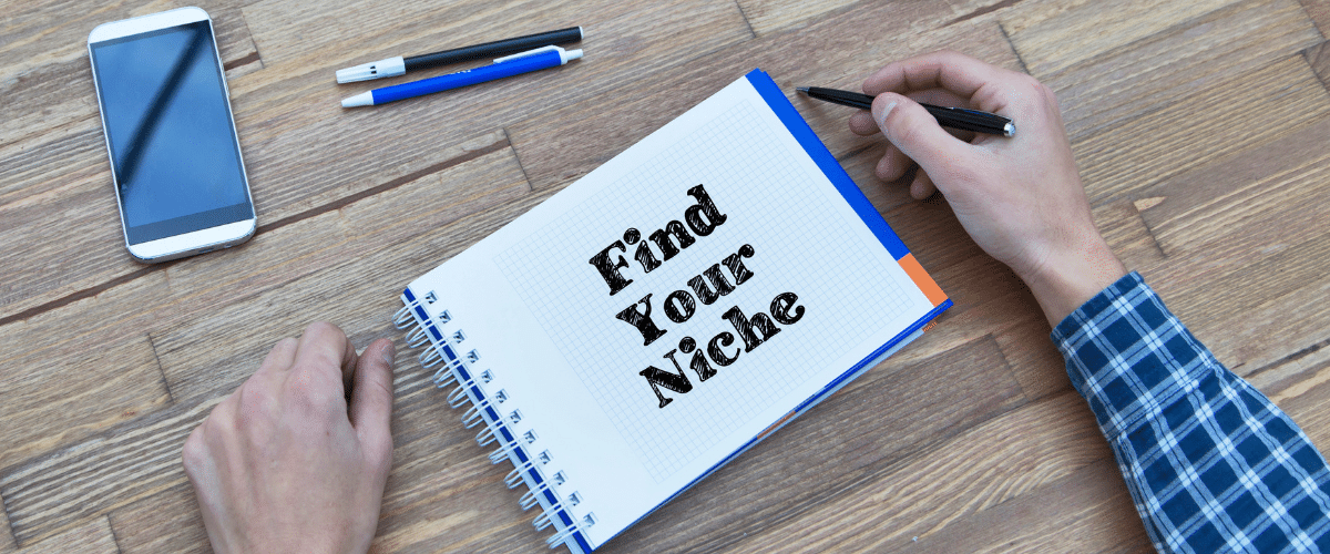 Image that shows someone with a note pad that says Find your Niche.